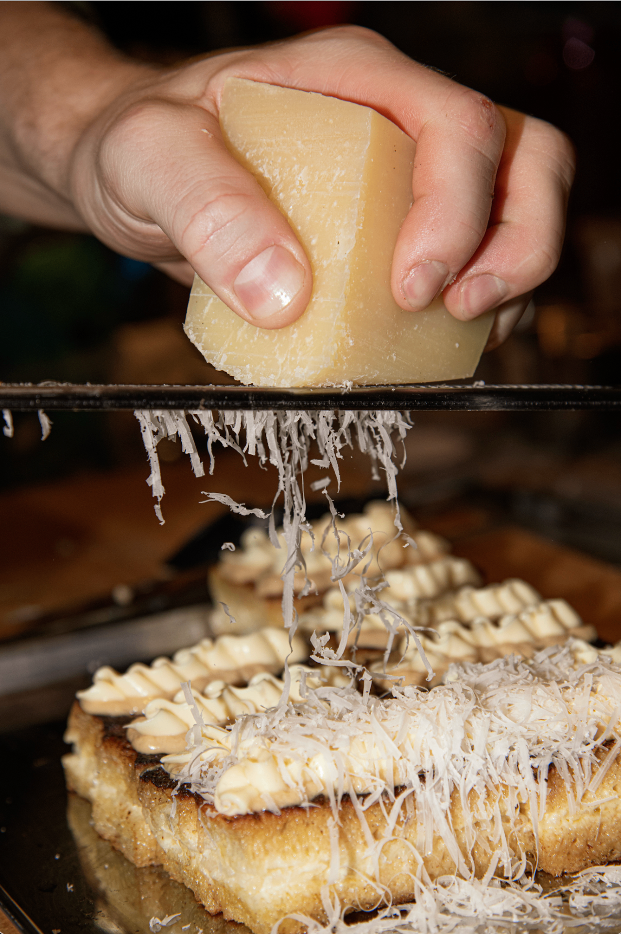 Aged cheese grated over toasted brioche